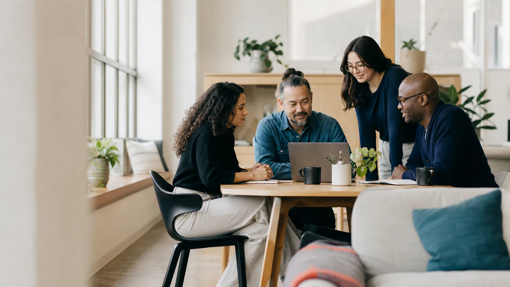 Illustrative generated scene of business professionals collaborating around a table in a bright contemporary workspace.